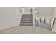 A carpeted staircase with modern railing ascends from a light gray wood-look floor at 9830 Wild Coyote Ct, Las Vegas, NV 89141