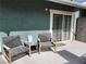 Outdoor patio with chairs, a side table, and a sliding glass door, perfect for relaxing and enjoying the outdoors at 1812 Ivanhoe Way, Las Vegas, NV 89102