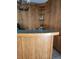 Wet bar featuring wood paneling, green counter, and glass shelving at 1812 Ivanhoe Way, Las Vegas, NV 89102