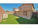 A lovely backyard featuring green artificial turf and a storage shed for outdoor essentials at 9614 Orchard Oasis Ct, Las Vegas, NV 89147