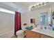 Well-lit bathroom featuring a vanity, toilet, and shower with red curtain at 9614 Orchard Oasis Ct, Las Vegas, NV 89147