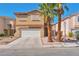 Charming two-story home with a well-maintained front yard and two palm trees at 9614 Orchard Oasis Ct, Las Vegas, NV 89147