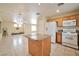 Kitchen with breakfast bar that opens to the living room, and tile floors at 9614 Orchard Oasis Ct, Las Vegas, NV 89147