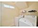 Convenient laundry room equipped with a washer and dryer at 9614 Orchard Oasis Ct, Las Vegas, NV 89147