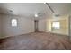 Spacious living room featuring neutral walls, carpeted floors, and a ceiling fan for added comfort at 9614 Orchard Oasis Ct, Las Vegas, NV 89147