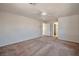 Open-concept living room with neutral walls, ceiling fan, and doorway to another room at 9614 Orchard Oasis Ct, Las Vegas, NV 89147