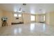Bright living room with tile flooring, ceiling fan, and natural light at 9614 Orchard Oasis Ct, Las Vegas, NV 89147