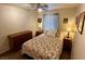 Cozy bedroom with floral bedding, a ceiling fan, and a dresser at 1011 Pecos River Ave, Henderson, NV 89002