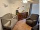 Bedroom features aircraft-themed wallpaper, a crib, and a changing table at 1011 Pecos River Ave, Henderson, NV 89002