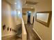 Bright hallway with hardwood floors leading to bedrooms and bathrooms upstairs at 1011 Pecos River Ave, Henderson, NV 89002