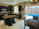 Modern kitchen featuring black cabinets, stainless steel appliances, granite countertops, island, and a breakfast nook at 1011 Pecos River Ave, Henderson, NV 89002