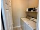 Bright laundry room with washer, dryer, and shelving for storage convenience at 1011 Pecos River Ave, Henderson, NV 89002