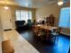 Inviting living room with a dining set, piano, dark wood floors, and plenty of natural light at 1011 Pecos River Ave, Henderson, NV 89002