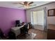 Bedroom with desk, purple wall, and ceiling fan at 1011 Pecos River Ave, Henderson, NV 89002