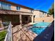 Spacious backyard with a sparkling pool, a covered patio, and plenty of room for entertaining and relaxing at 1011 Pecos River Ave, Henderson, NV 89002