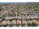 Wide aerial shot captures a neighborhood with multiple homes, streets, and landscaping, all framed by distant mountains at 10513 Shanna Trellis Ave, Las Vegas, NV 89144
