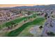 Panoramic aerial shot of a golf course community with residential homes, lush green fairways, and scenic landscaping at 10513 Shanna Trellis Ave, Las Vegas, NV 89144