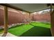 Backyard features artificial turf, decorative rocks, and a covered patio at 10513 Shanna Trellis Ave, Las Vegas, NV 89144