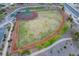 Aerial view of a baseball field in a well maintained community with sidewalk and greenery at 10513 Shanna Trellis Ave, Las Vegas, NV 89144