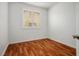 Well-lit bedroom featuring wood floors, a window with shutters, and white walls at 10513 Shanna Trellis Ave, Las Vegas, NV 89144