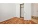 Bedroom with wood floors and a closet featuring open sliding doors at 10513 Shanna Trellis Ave, Las Vegas, NV 89144