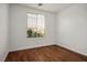 Clean, bright bedroom with hardwood floors and a window with blinds at 10513 Shanna Trellis Ave, Las Vegas, NV 89144