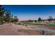 Scenic view of a golf course showcasing its manicured greens, mature trees, and a clear blue sky at 10513 Shanna Trellis Ave, Las Vegas, NV 89144