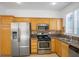 This kitchen features stainless appliances, granite countertops, and custom wood cabinets at 10513 Shanna Trellis Ave, Las Vegas, NV 89144