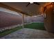 Covered patio with tile flooring, artificial turf, and decorative wagon wheel accents at 10513 Shanna Trellis Ave, Las Vegas, NV 89144