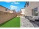 Backyard featuring a small lawn, brick wall, and a patio set at 10973 Sardinia Sands Dr, Las Vegas, NV 89141