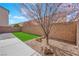 Landscaped backyard with a mix of turf, decorative rock, and concrete areas at 10973 Sardinia Sands Dr, Las Vegas, NV 89141