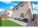 Backyard area featuring an outdoor dining set and drought-tolerant landscaping at 10973 Sardinia Sands Dr, Las Vegas, NV 89141