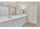 Bright bathroom with double sinks, spacious white vanity, and vanity mirrors at 10973 Sardinia Sands Dr, Las Vegas, NV 89141