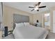 Bright bedroom with large gray headboard, ceiling fan, and lots of natural light at 10973 Sardinia Sands Dr, Las Vegas, NV 89141