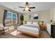 Bright bedroom featuring a ceiling fan, large window and neutral decor at 10973 Sardinia Sands Dr, Las Vegas, NV 89141