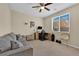 Comfortable bedroom with a gray couch, desk, and backyard view at 10973 Sardinia Sands Dr, Las Vegas, NV 89141