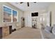 Spacious bedroom featuring a gray couch, shelves, and backyard view at 10973 Sardinia Sands Dr, Las Vegas, NV 89141