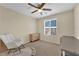 Bright bedroom featuring a ceiling fan, dresser, and alphabet rug at 10973 Sardinia Sands Dr, Las Vegas, NV 89141