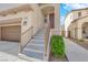 Inviting front entrance with stairs leading to the front door and a view of the attached two-car garage at 10973 Sardinia Sands Dr, Las Vegas, NV 89141
