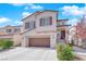 Charming two-story home featuring a large garage, neutral colors, manicured landscaping, and inviting front entrance at 10973 Sardinia Sands Dr, Las Vegas, NV 89141