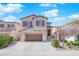 Charming two-story home featuring a landscaped front yard and attached garage at 10973 Sardinia Sands Dr, Las Vegas, NV 89141