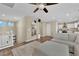 Spacious living room with hardwood floors, a comfortable sectional sofa, and an open layout to the kitchen at 10973 Sardinia Sands Dr, Las Vegas, NV 89141