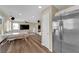Open-concept living space with sightlines from the modern kitchen and dining area to the comfortable living room at 10973 Sardinia Sands Dr, Las Vegas, NV 89141