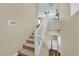 Interior shot of a staircase leading upstairs, showing the open railing, laundry area, and natural light at 10973 Sardinia Sands Dr, Las Vegas, NV 89141