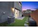 Faux grass in the backyard, a brick wall, and an AC unit at 11325 Gravitation Dr, Las Vegas, NV 89135
