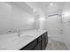 Bright bathroom showcasing double sink vanity, tiled floor, and modern fixtures at 11325 Gravitation Dr, Las Vegas, NV 89135