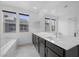 Primary bath boasts double sink vanity, large mirror, and separate tub at 11325 Gravitation Dr, Las Vegas, NV 89135