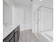 Bright bath features glass shower, tub, and double sinks with modern vanity at 11325 Gravitation Dr, Las Vegas, NV 89135