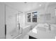 Modern bathroom featuring glass shower, soaking tub, and double sink vanity at 11325 Gravitation Dr, Las Vegas, NV 89135