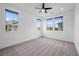 Bright bedroom featuring neutral carpet, ceiling fan, recessed lights and abundant natural light at 11325 Gravitation Dr, Las Vegas, NV 89135